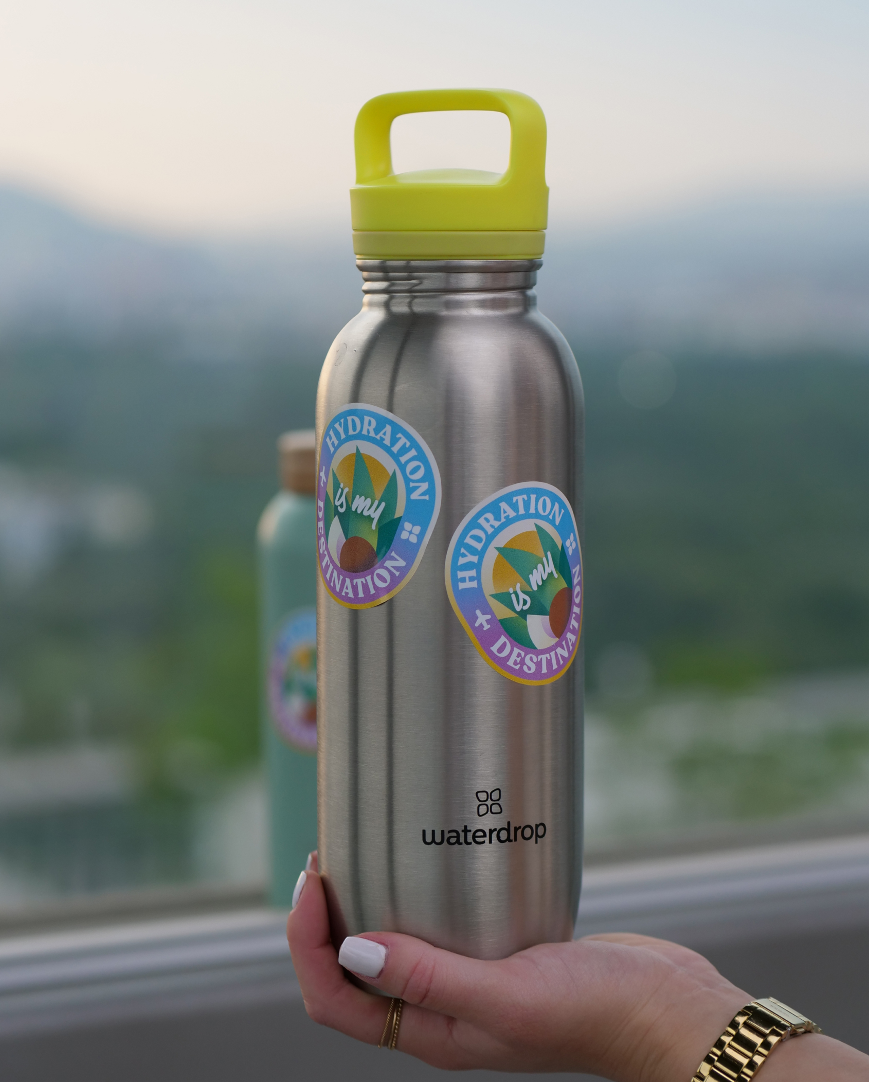 Sticker pour Bouteille on a water bottle outdoors.