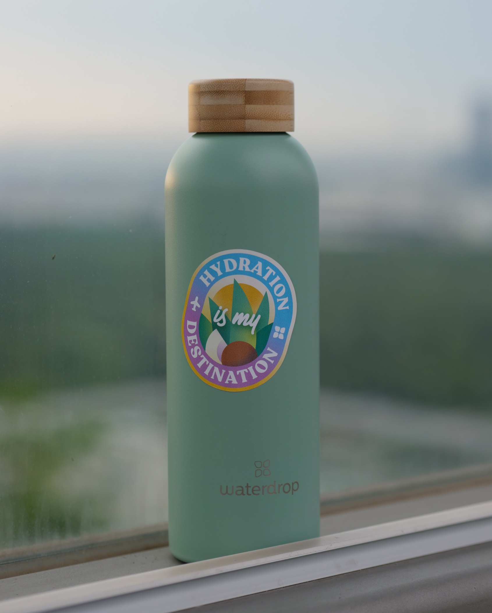 Sticker pour Bouteille on a windowsill.