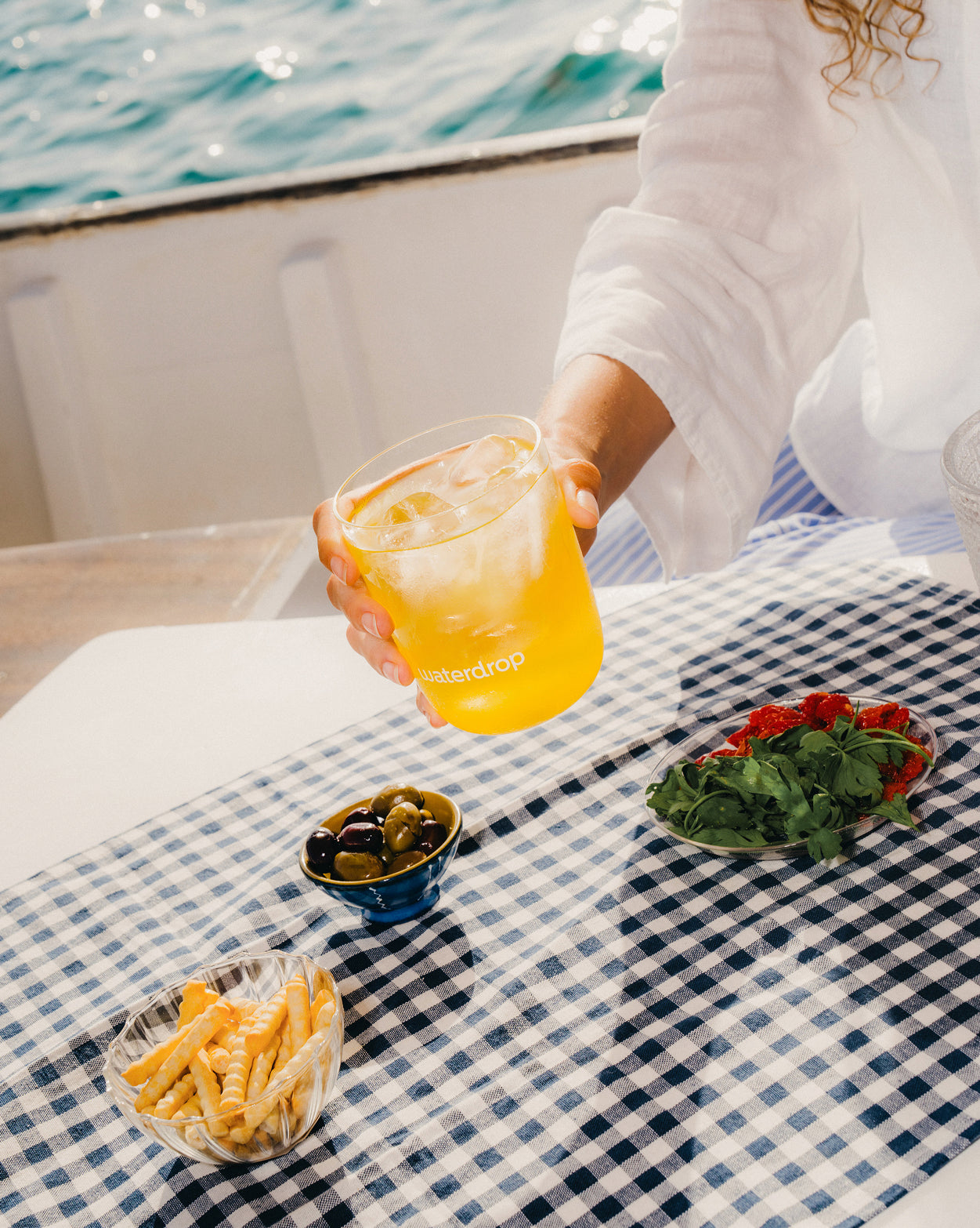 ORANGE Microdrink near olives and fries.
